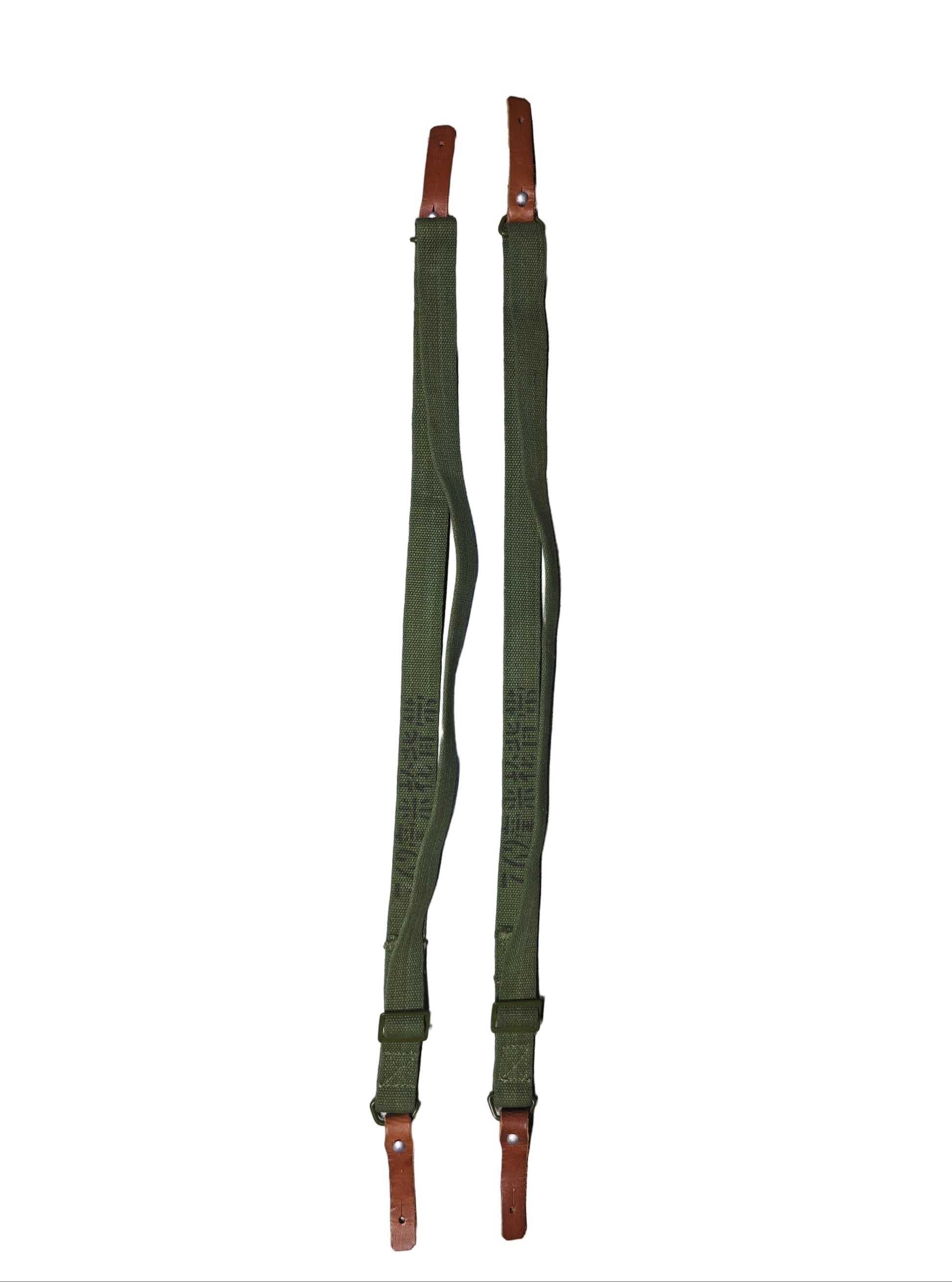 Two type 56 chinese sks green straps with brown ends on a gray surface.