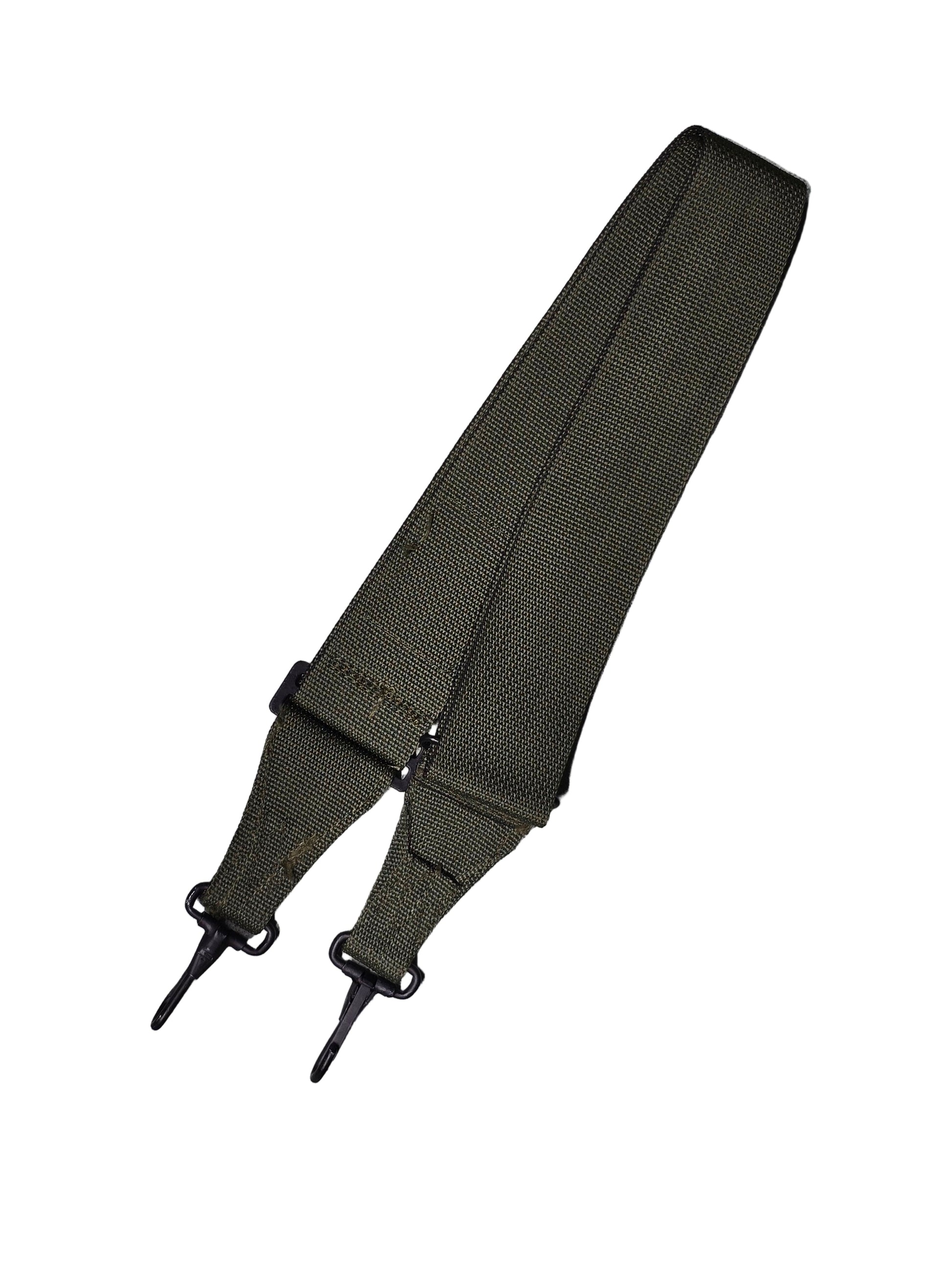 Black strap with buckles on a gray surface