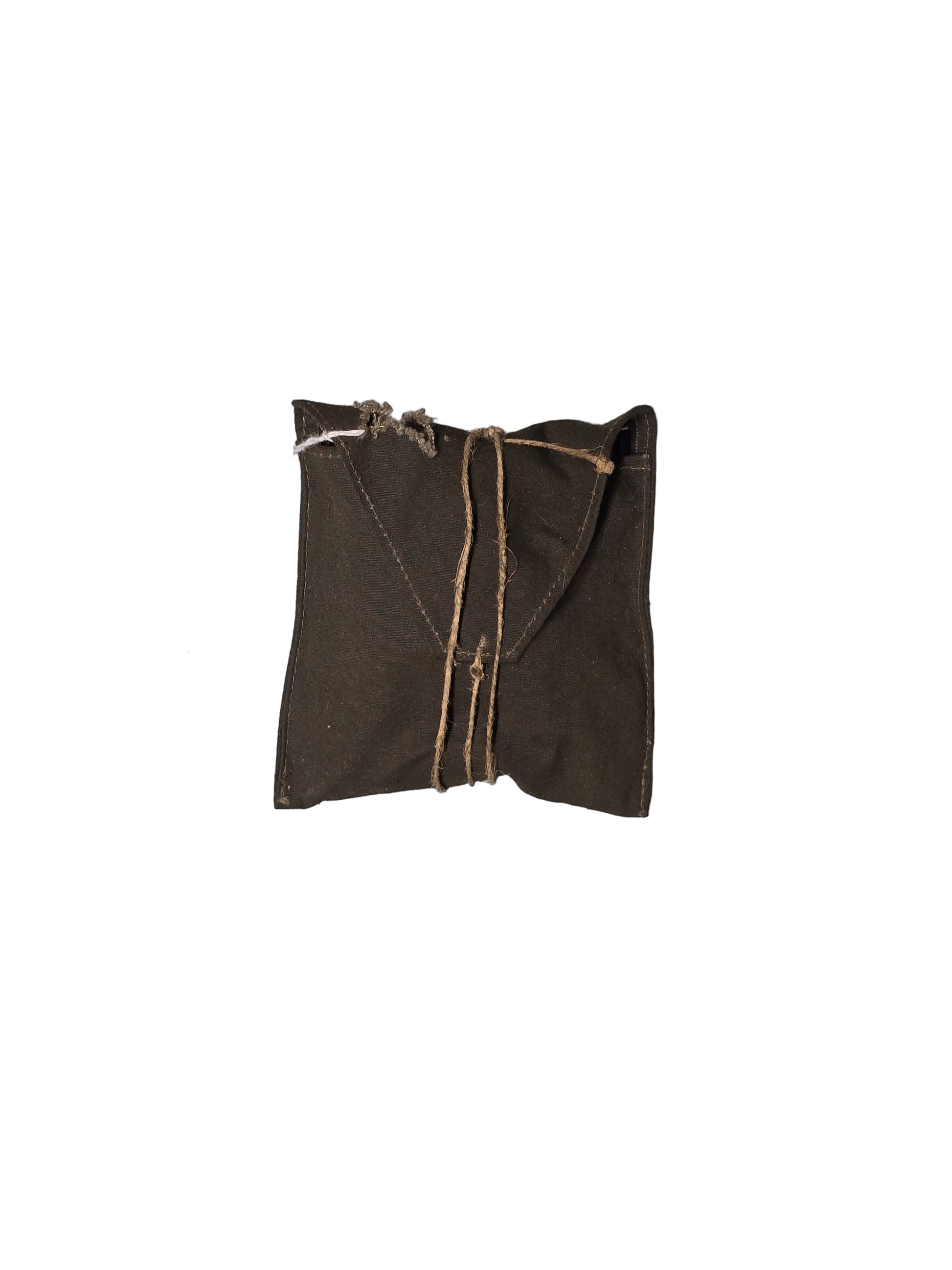 Brown fabric package tied with twine on a gray surface