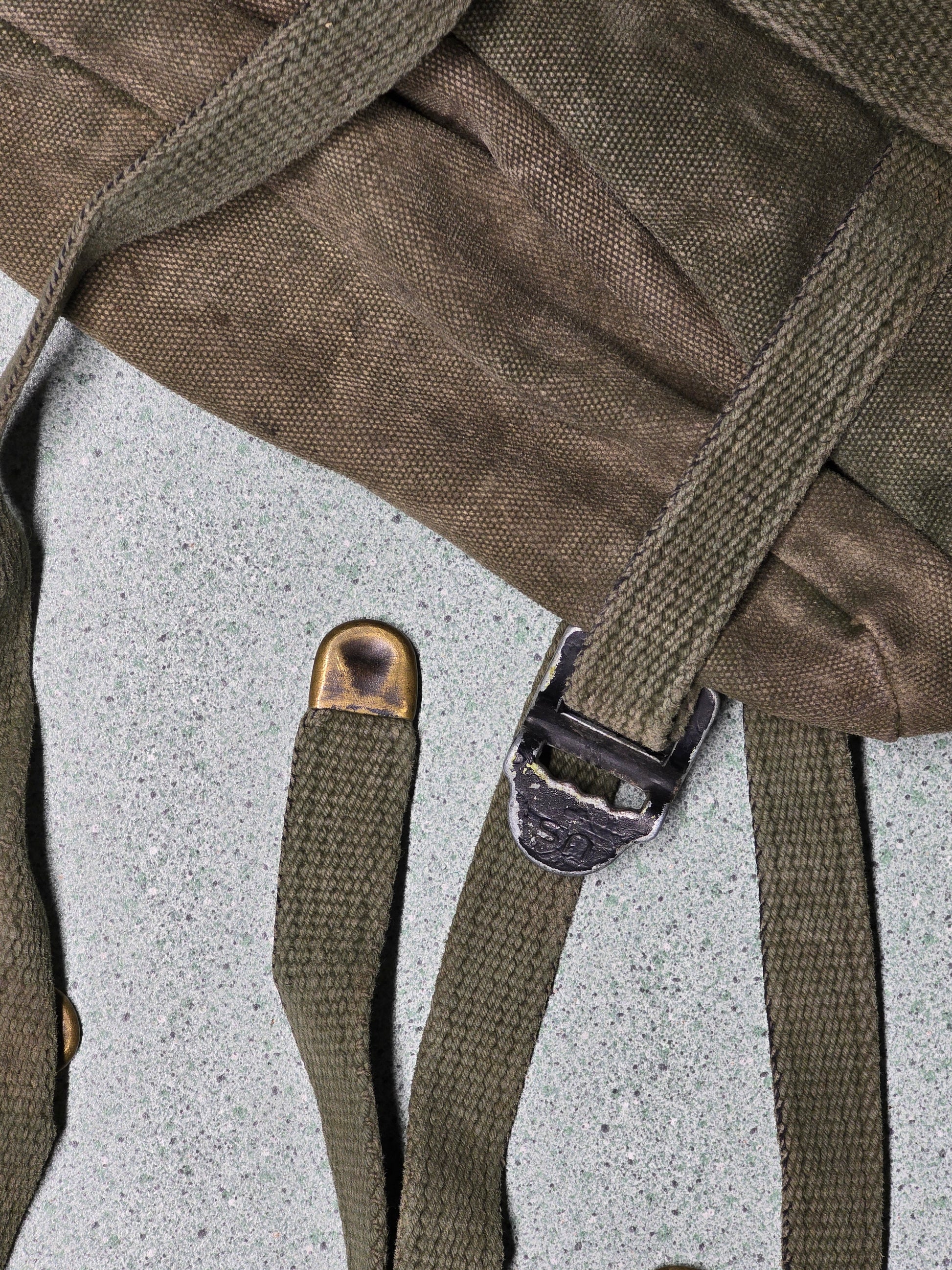 U.S. M-1961 Vietnam War "Field Pack Canvas" Bags Vintage military backpack on a gray background Close-up of a brown backpack with straps on a textured surface