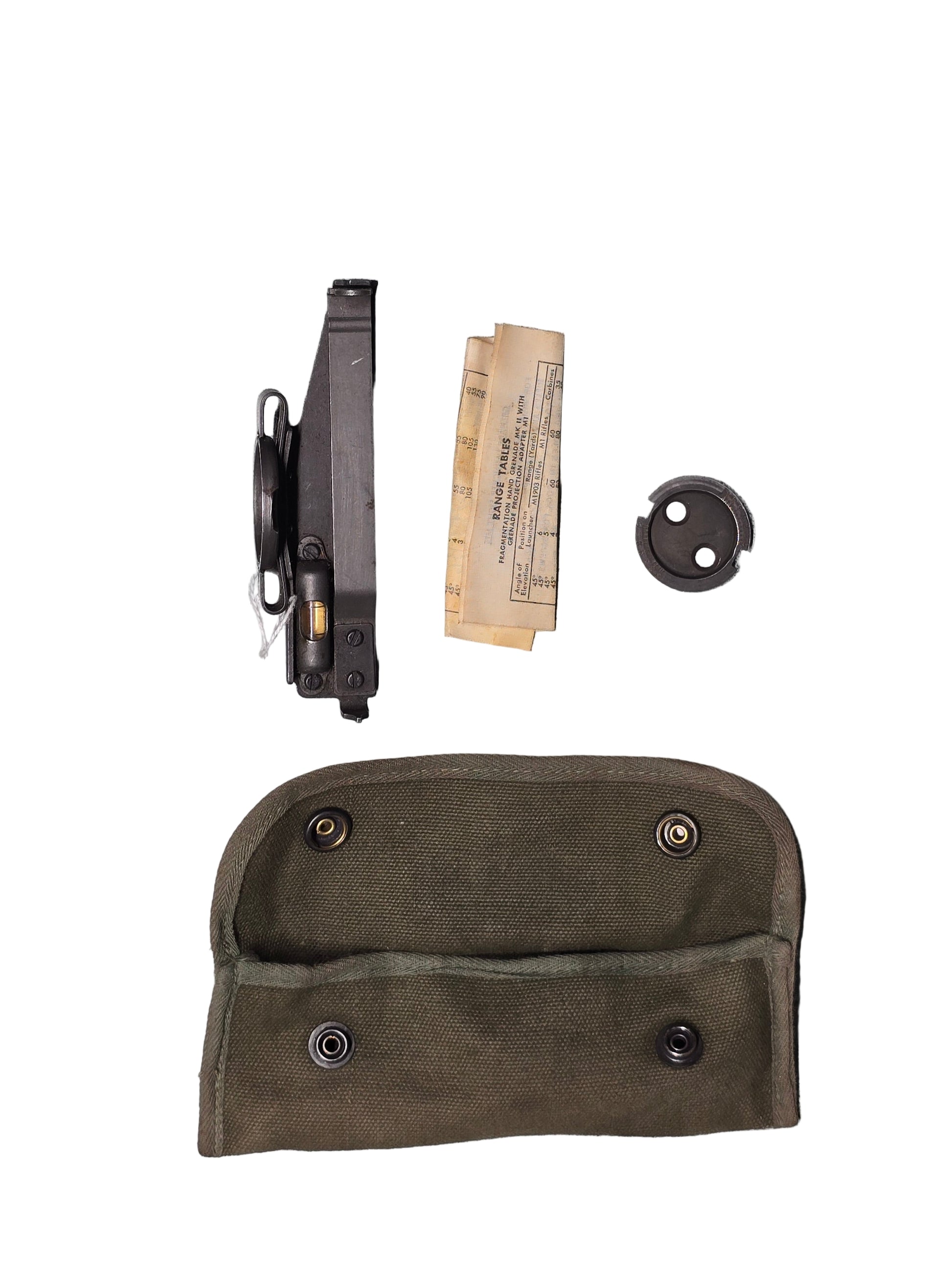 U.S. M15 Grenade Launcher sight, Weapon components including a magazine, clip, and paper on a gray surface