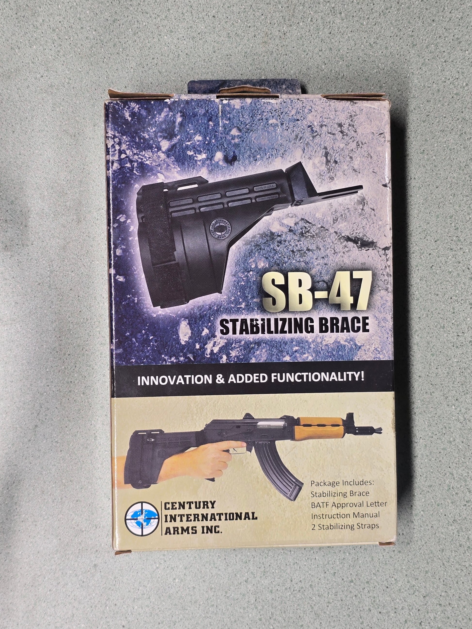 Product packaging for SB-47 stabilizing brace with graphics of a rifle on a gray background