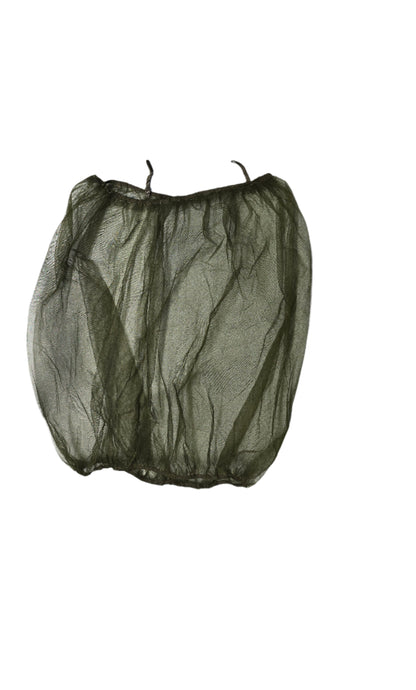 Green mesh bag on a light gray surface with various items in the background